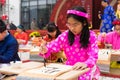 Hanoi, Vietnam - Feb 7, 2015: School children in traditional dress Ao Dai learning with calligraphy at Vietnamese lunar New Year c