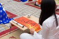 Hanoi, Vietnam - Feb 7, 2015: School children in traditional dress Ao Dai learning with calligraphy at Vietnamese lunar New Year c