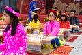 Hanoi, Vietnam - Feb 7, 2015: School children in traditional dress Ao Dai learning with calligraphy at Vietnamese lunar New Year c