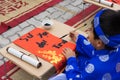 Hanoi, Vietnam - Feb 7, 2015: School children in traditional dress Ao Dai learning with calligraphy at Vietnamese lunar New Year c
