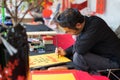 Hanoi, Vietnam - Feb 15, 2015: Vietnamese scholar at lunar new year calligraphy festival organizing at Temple of Literature Van Mi
