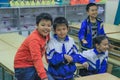 a group of elementary school boys students in the classroom laugh and play at recess