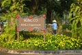 Hanoi, Vietnam - Jan 1, 2016: Aparment board sign with Asian woman watering a green and floral garden at Ecopark residential villa Royalty Free Stock Photo