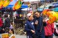 Hanoi, Vietnam - Jan 26, 2017: A mother and her son take a walk buying decoration and flower for Vietnamese lunar new year on Hang Royalty Free Stock Photo