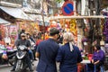 Hanoi, Vietnam - Jan 26, 2017: A mother and her son take a walk buying decoration and flower for Vietnamese lunar new year on Hang Royalty Free Stock Photo