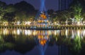 An ancient Turtle tower in the spotlight on Hoan Kiem Lake at night. Hanoi, Vietnam