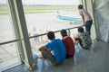 Hanoi, Vietnam - July 12, 2015: Asian customers look at airplane while waiting for boarding time at Noi Bai International Airport,