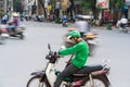 Hanoi, Vietnam - July 7, 2017: Grab motorbike driver waiting for customer on Ba Trieu street. Entered Vietnam in 2014, Grab growin