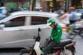 Hanoi, Vietnam - July 7, 2017: Grab motorbike driver waiting for customer on Ba Trieu street. Entered Vietnam in 2014, Grab growin