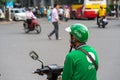 Hanoi, Vietnam - July 7, 2017: Grab motorbike driver waiting for customer on Ba Trieu street. Entered Vietnam in 2014, Grab growin