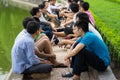 Hanoi, Vietnam - July 3, 2016: Group of students learn to speak English with English native foreigners at Hoan Kiem lake. A lot of