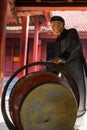 Hanoi, Vietnam - July 24, 2016: Old man beating drum made of wood and water buffalo leather at Temple of Literature, Hanoi. The ma Royalty Free Stock Photo