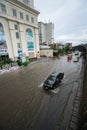 Hanoi, Vietnam - July 17, 2017: Traffic on flooded Minh Khai street after heavy rain with cars, motorcycles crossing deep water