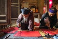 Scholar writes Chinese calligraphy characters in communal house at So village, Quoc Oai district.