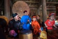 Hanoi, Vietnam - Jun 22, 2017: Vietnamese old traditional folk singer with children learning to play folk instruments in communal Royalty Free Stock Photo