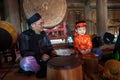 Hanoi, Vietnam - Jun 22, 2017: Vietnamese old traditional folk singer with children learning to play folk instruments in communal Royalty Free Stock Photo