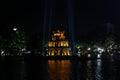 The ancient Turtle Tower in the middle of the Hoan Kiem lake in the city of Hanoi illuminated at night