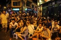 A crowded street corner in the old quarter of the city of Hanoi with young people enjoying Bia Hoi aka Royalty Free Stock Photo