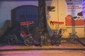 Cyclos parked on a roadside pavement at night in the old quarter of Hanoi