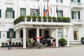 Hanoi, Vietnam - Mar 15, 2015: External front view of Hotel Sofitel Legend Metropole Hanoi with running cyclo. Sofitel Legend Metr