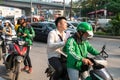 Hanoi, Vietnam - Mar 21, 2019: Grab bike taxi man with customer at Dao Tan street