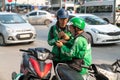 Hanoi, Vietnam - Mar 21, 2019: Grab bike taxi man using smartphone at Dao Tan street