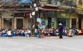 Hanoi, Vietnam - Mar 15, 2015: People drink coffee, tea or juice fruit on cafe stall on sidewalk in Nha Tho street, center of Hano