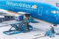 Vietnam Airlines aircraft loading air cargo containers before flight at Noi Bai international airport in Hanoi, Vietnam Royalty Free Stock Photo