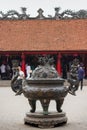 A Big antique bronze incense burner with tourist background in the House of Ceremonies at Temple of Literature Original built in