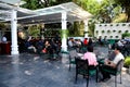 Patrons at outdoor street side upscale cafe in Old Quarter Hanoi Vietnam