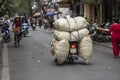 Transportation of goods by motorcycle on the street in old town Hanoi, Vietnam Royalty Free Stock Photo