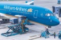 Vietnam Airlines aircraft loading air cargo containers before flight at Noi Bai international airport in Hanoi, Vietnam Royalty Free Stock Photo