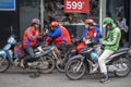 Vietnamese guys rest on motorbike taxi on street in old town Hanoi , Vietnam