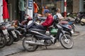 Vietnamese man rest on motorbike taxi on street in old town Hanoi , Vietnam