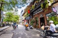 Hanoi, Vietnam - May 28, 2023: Enchanting Old town streets reveal a vibrant tableau: motorcycles and bicycles whizzing by,