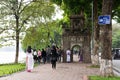 Hanoi, Vietnam - Nov 16, 2014: Corner view of Hoan Kiem lake, with Hoa Phong ancient tower, people taking a walk and shooting some