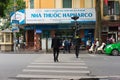 Hanoi, Vietnam - Nov 16, 2014: Perspective of Pharmacy front view and people crossing street on Hang Khay street, near Hoan Kiem l Royalty Free Stock Photo