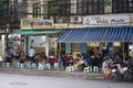 Hanoi, Vietnam - Nov 9, 2014: Typical cafe in Thai Phien street. People sit on small plastic seat having coffee, tea or fruit juic