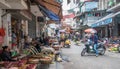 Busy local daily life of the morning street market in Hanoi, Vietnam. A busy crowd of sellers and buyers in the market. Royalty Free Stock Photo