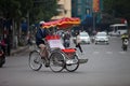 Hanoi, Vietnam - November 21, 2019: Street vendors are hurriedly cycling across the street to find customers in the small neighbor