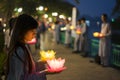 Hanoi, Vietnam - Oct 10, 2014: Buddhists hold flower garlands and colored lanterns for celebrating Buddha`s birthday organised at