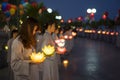 Hanoi, Vietnam - Oct 10, 2014: Buddhists hold flower garlands and colored lanterns for celebrating Buddha`s birthday organised at Royalty Free Stock Photo