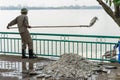 Hanoi, Vietnam - Oct 2, 2016: Garbage collector, environment workers take mass dead fishes out from West Lake Royalty Free Stock Photo