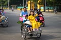 Hanoi, Vietnam - Oct 16, 2016: Vietnamese girl wears traditional long dress Ao Dai going by Cyclo pedicab on Hanoi street Royalty Free Stock Photo