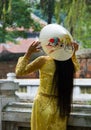 Hanoi, Vietnam / Oct 20, 2011: Woman tries on hat