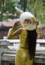 Hanoi, Vietnam - Oct 20, 2011: Woman tries on hat