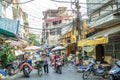 Busy local daily life of the morning street market in Hanoi, Vietnam. A busy crowd of sellers and buyers in the market.