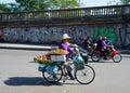 Street vendor on bicycle bring goods to food market in the Old Quarter of Hanoi, Vietnam Royalty Free Stock Photo