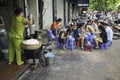 Hanoi, Vietnam - Sep 2, 2015: People eating Vietnamese traditional noodle soup Pho on sidewalk. Eating on pavement is common in Ha Royalty Free Stock Photo