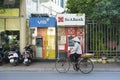 Hanoi, Vietnam - Sep 14, 2014: Unidentified woman cycles passing ATM on Le Dai Hanh street